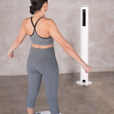 Woman using Styku body scanner.